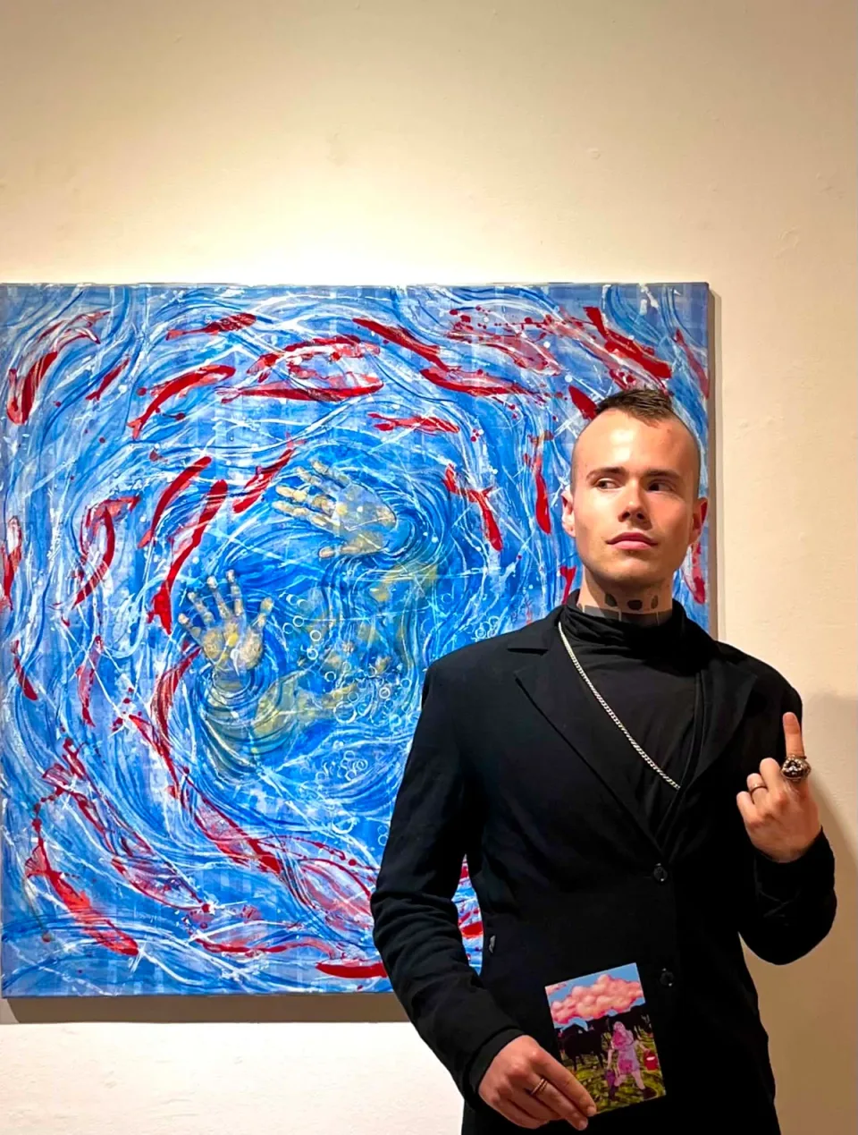 Guest photographed in front of an artwork at the Identity group exhibition in Seoul.